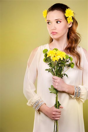 simsearch:400-07986693,k - cuacasian woman wearing yellow flowers on green background Stock Photo - Budget Royalty-Free & Subscription, Code: 400-08131695