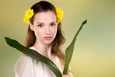 simsearch:400-07986693,k - cuacasian woman wearing yellow flowers on green background Stock Photo - Budget Royalty-Free & Subscription, Code: 400-08131696