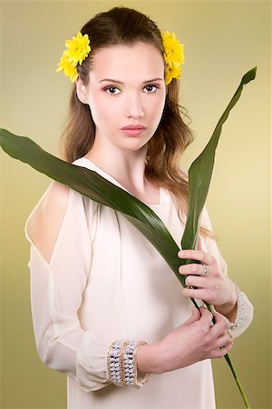 simsearch:400-07986693,k - cuacasian woman wearing yellow flowers on green background Stock Photo - Budget Royalty-Free & Subscription, Code: 400-08131697