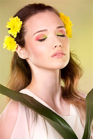simsearch:400-07986693,k - cuacasian woman wearing yellow flowers on green background Stock Photo - Budget Royalty-Free & Subscription, Code: 400-08131699