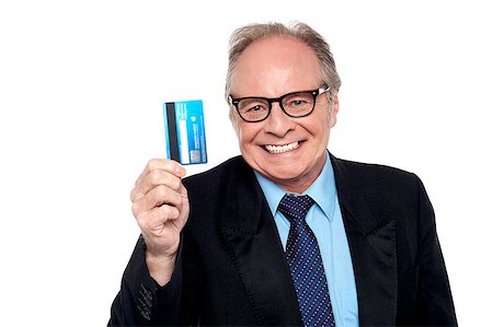 Business concept, old man wearing eyeglasses holding up a cash card. Foto de stock - Super Valor sin royalties y Suscripción, Código: 400-08131772