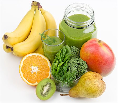 Green smoothie in a glass and in a open jar with fresh kale, spinach and carrot leafs. A raw, healthy and vegan drink made of green leafs and fruits. Stock Photo - Budget Royalty-Free & Subscription, Code: 400-08132366