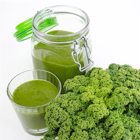 Green smoothie in a glass and in a open jar with fresh kale. A raw, healthy and vegan beverage made of green leafs and fruits. Stock Photo - Budget Royalty-Free & Subscription, Code: 400-08132368