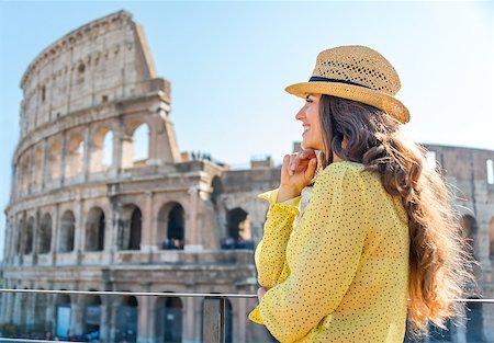 simsearch:400-07956611,k - A woman tourist is standing, leaning her chin on her hands, and looking into the distance and smiling. She is admiring the views. In the distance, the Colosseum on a hot summer's day. Foto de stock - Royalty-Free Super Valor e Assinatura, Número: 400-08133752