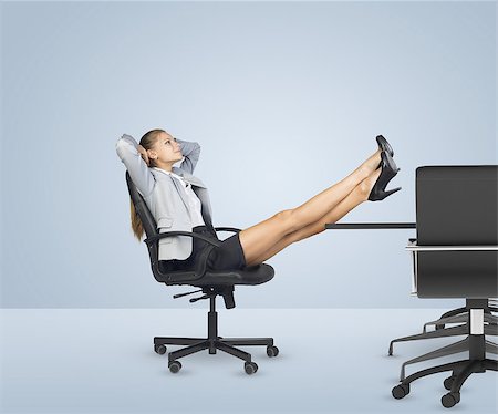 Businesslady sitting in chair with her hands behind head. Looking up and crossing legs Stock Photo - Budget Royalty-Free & Subscription, Code: 400-08154349
