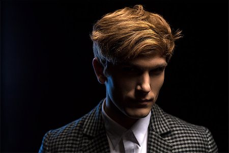 dark young men in business casual - Portrait of red-haired handsome guy on a black background in the studio Photographie de stock - Aubaine LD & Abonnement, Code: 400-08154592