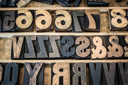 A vintage drawer of old wooden letterpress letters, numbers, and symbols. Type is ink stained and photographed with the letters naturally backwards as they normally appear before printing. Stock Photo - Budget Royalty-Free & Subscription, Code: 400-08154880