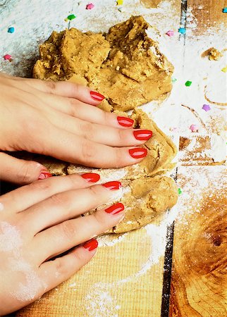 Hands of Women with Red Manicure Making Gingerbread Dough with Flour and Sweet Decoration closeup on Wooden background Stock Photo - Budget Royalty-Free & Subscription, Code: 400-08154918