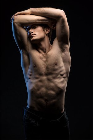 simsearch:400-04649175,k - Portrait of handsome red-haired athlete topless at the studio on a black background in low key Stock Photo - Budget Royalty-Free & Subscription, Code: 400-08155076