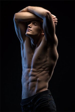 Portrait of handsome red-haired athlete topless at the studio on a black background in low key Stock Photo - Budget Royalty-Free & Subscription, Code: 400-08155570