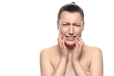 Close up Young Woman Wearing Tube Tops, Suffering From a Very Painful Toothache, Holding her Face While Crying at the Camera. Isolated on White Background Stock Photo - Budget Royalty-Free & Subscription, Code: 400-08156464