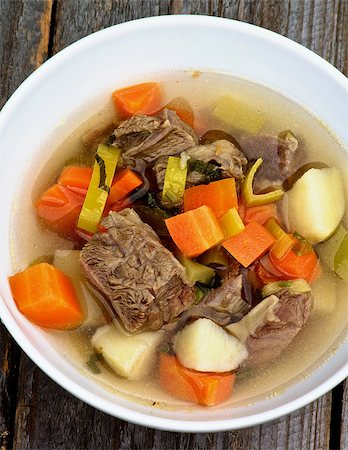 simsearch:400-07478286,k - Homemade Beef Soup with Potato, Carrot and Leek in White Bowl Cross Secyion on Wooden background. Top View Stock Photo - Budget Royalty-Free & Subscription, Code: 400-08156803