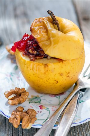 simsearch:400-06946823,k - Baked apple with nuts and cowberry on an old table. Fotografie stock - Microstock e Abbonamento, Codice: 400-08157229