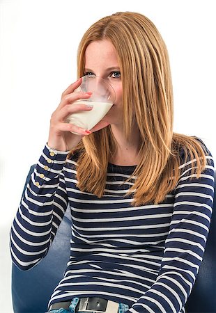 Smiling young girl drinking a glass of milk on a white background Stock Photo - Budget Royalty-Free & Subscription, Code: 400-08158197