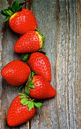 simsearch:400-08020671,k - Perfect Raw Ripe Strawberries In a Row isolated on Rustic Wooden background. Top View Stock Photo - Budget Royalty-Free & Subscription, Code: 400-08159812