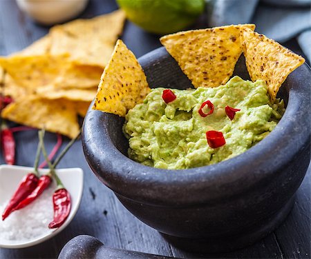 simsearch:400-06689258,k - black stone bowl with fresh guacamole and nachos for dip Stock Photo - Budget Royalty-Free & Subscription, Code: 400-08151286