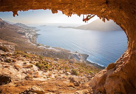 simsearch:400-07292725,k - Male rock climber climbing along a roof in a cave. Kalymnos island, Greece. Photographie de stock - Aubaine LD & Abonnement, Code: 400-08151293