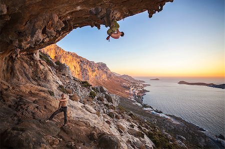 simsearch:400-07292725,k - Male rock climber climbing on a roof in a cave, his partner belaying Photographie de stock - Aubaine LD & Abonnement, Code: 400-08151302