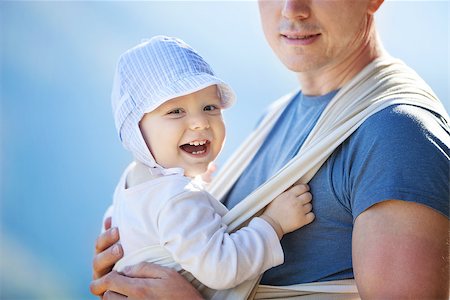 Happy toddler boy in sling, father carrying son outdoors Stock Photo - Budget Royalty-Free & Subscription, Code: 400-08151324