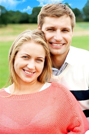 Closeup shot of an attractive love couple. Man hugging his wife from behind Stock Photo - Budget Royalty-Free & Subscription, Code: 400-08151372
