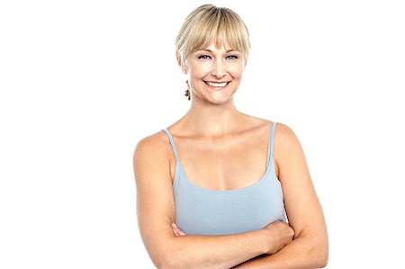 Trendy woman in sleeveless spaghetti top posing with folded arms. Stock Photo - Budget Royalty-Free & Subscription, Code: 400-08151422