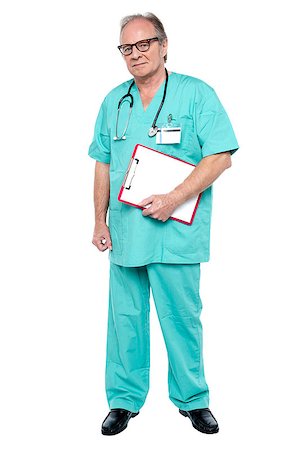 simsearch:400-05745246,k - Portrait of grim faced doctor holding a clipboard standing against white background. Photographie de stock - Aubaine LD & Abonnement, Code: 400-08151458