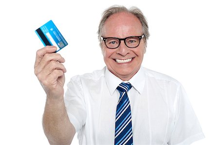 Cheerful aged employer holding up a cash card and smiling at the camera. Stock Photo - Budget Royalty-Free & Subscription, Code: 400-08151477
