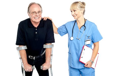 simsearch:400-07976358,k - Cheerful doctor encouraging her patient to walk with crutches, smiling faces. Stock Photo - Budget Royalty-Free & Subscription, Code: 400-08151495