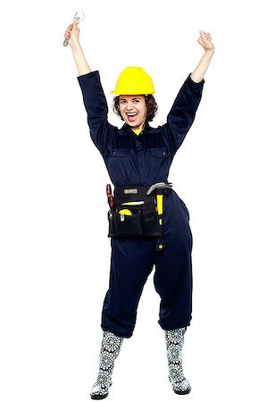 Jubilant young craftswoman throwing her arms up in excitement. Stock Photo - Budget Royalty-Free & Subscription, Code: 400-08151807