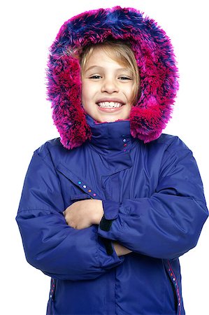 Sweet little girl in warm clothing standing with arms crossed. Stockbilder - Microstock & Abonnement, Bildnummer: 400-08151903