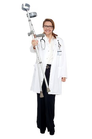 simsearch:400-05745246,k - Full length portrait of medical expert displaying crutches to the camera. Photographie de stock - Aubaine LD & Abonnement, Code: 400-08152043