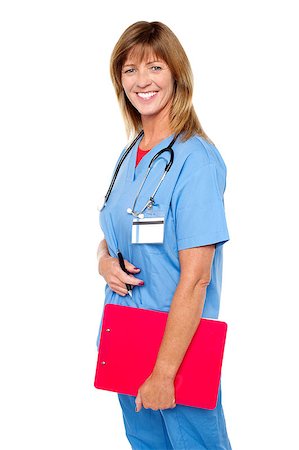 simsearch:400-08131186,k - Side profile of a cheerful middle aged nurse posing with clipboard in hand. Stock Photo - Budget Royalty-Free & Subscription, Code: 400-08152097