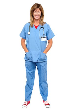 simsearch:400-08131186,k - Full length portrait of a blonde doctor in uniform posing with hands in pocket. Stock Photo - Budget Royalty-Free & Subscription, Code: 400-08152101
