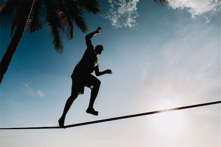 teenage balancing on slackline with sky view on the beach silhouette Stock Photo - Budget Royalty-Free & Subscription, Code: 400-08152362