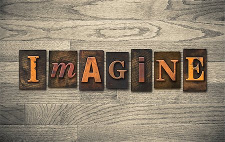 simsearch:400-08343539,k - The word "IMAGINE" theme written in vintage, ink stained, wooden letterpress type on a wood grained background. Photographie de stock - Aubaine LD & Abonnement, Code: 400-08152405