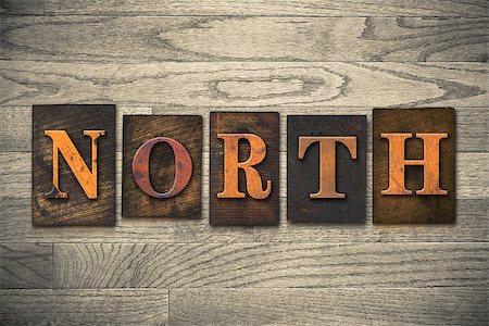 simsearch:400-08152413,k - The word "NORTH" theme written in vintage, ink stained, wooden letterpress type on a wood grained background. Foto de stock - Super Valor sin royalties y Suscripción, Código: 400-08152413