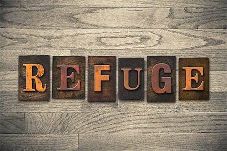 The word "REFUGE" theme written in vintage, ink stained, wooden letterpress type on a wood grained background. Photographie de stock - Aubaine LD & Abonnement, Code: 400-08152422