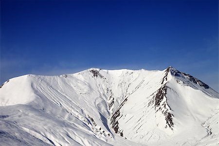 simsearch:400-08530488,k - Snowy mountains in wind day. Caucasus Mountains. Georgia, ski resort Gudauri. Stock Photo - Budget Royalty-Free & Subscription, Code: 400-08152503