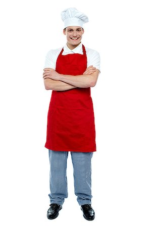 Handsome young cook posing in uniform with arms crossed, full length portrait Stock Photo - Budget Royalty-Free & Subscription, Code: 400-08153004