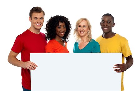 Group of youth displaying blank advertise board and smiling at camera Stock Photo - Budget Royalty-Free & Subscription, Code: 400-08153187