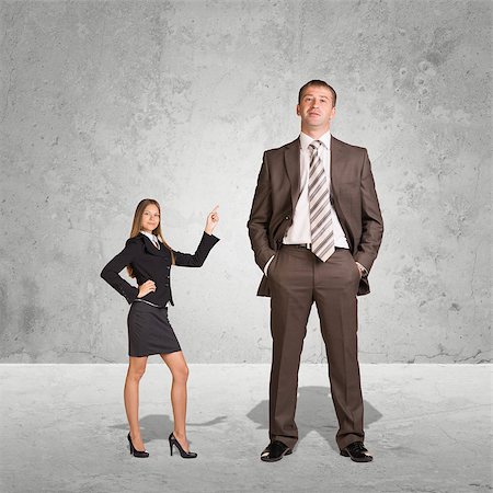 standing tall concept business - Small Young Businesswoman and Large Businessman. Concrete background Stock Photo - Budget Royalty-Free & Subscription, Code: 400-08153344