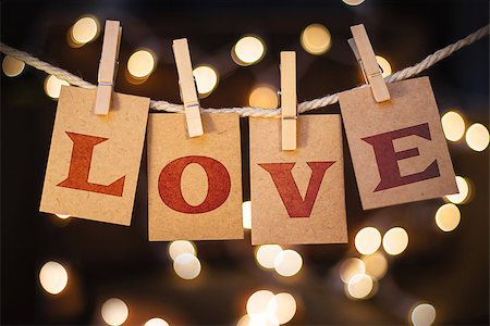 simsearch:400-08153760,k - The word LOVE spelled out on clothespin clipped cards in front of glowing lights. Stockbilder - Microstock & Abonnement, Bildnummer: 400-08153420
