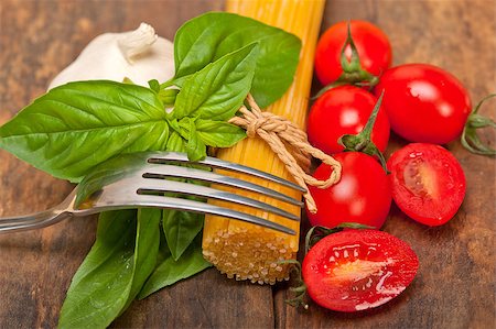 simsearch:695-05773492,k - raw ingredients spaghetti pasta tomato and basil foundations of Italian cuisine Fotografie stock - Microstock e Abbonamento, Codice: 400-08153791