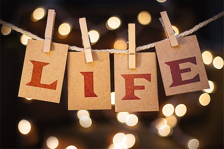 simsearch:400-08153760,k - The word LIFE printed on clothespin clipped cards in front of defocused glowing lights. Stockbilder - Microstock & Abonnement, Bildnummer: 400-08153831