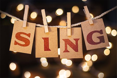 simsearch:400-08153760,k - The word SING printed on clothespin clipped cards in front of defocused glowing lights. Stockbilder - Microstock & Abonnement, Bildnummer: 400-08153845