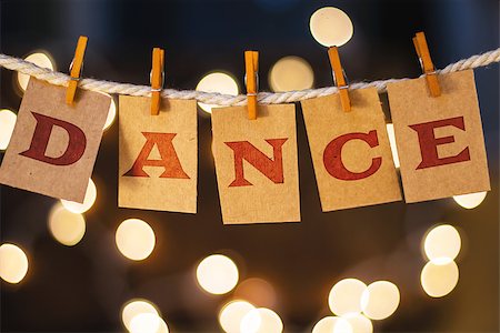 simsearch:400-08153760,k - The word DANCE printed on clothespin clipped cards in front of defocused glowing lights. Stockbilder - Microstock & Abonnement, Bildnummer: 400-08153926