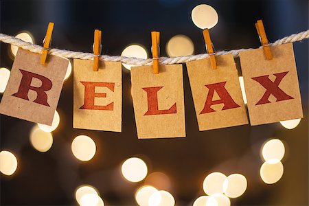 simsearch:400-08153760,k - The word RELAX printed on clothespin clipped cards in front of defocused glowing lights. Stockbilder - Microstock & Abonnement, Bildnummer: 400-08153956