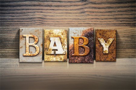 simsearch:400-08166276,k - The word "BABY" written in rusty metal letterpress type sitting on a wooden ledge background. Stock Photo - Budget Royalty-Free & Subscription, Code: 400-08164131