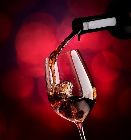 simsearch:400-04264239,k - Wine pouring in wineglass on a vinous background Stock Photo - Budget Royalty-Free & Subscription, Code: 400-08164490