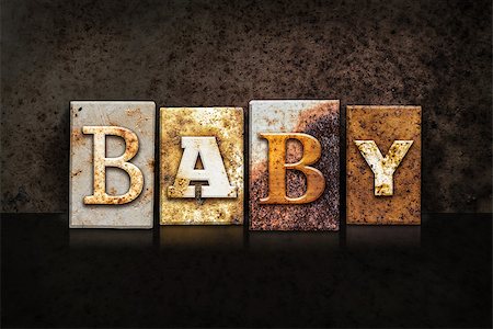 simsearch:400-08166276,k - The word "BABY" written in rusty metal letterpress type on a dark textured grunge background. Stock Photo - Budget Royalty-Free & Subscription, Code: 400-08164753